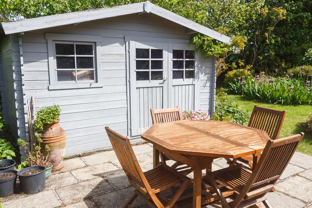 a a blue shed made from log cabin wood and shed timber 