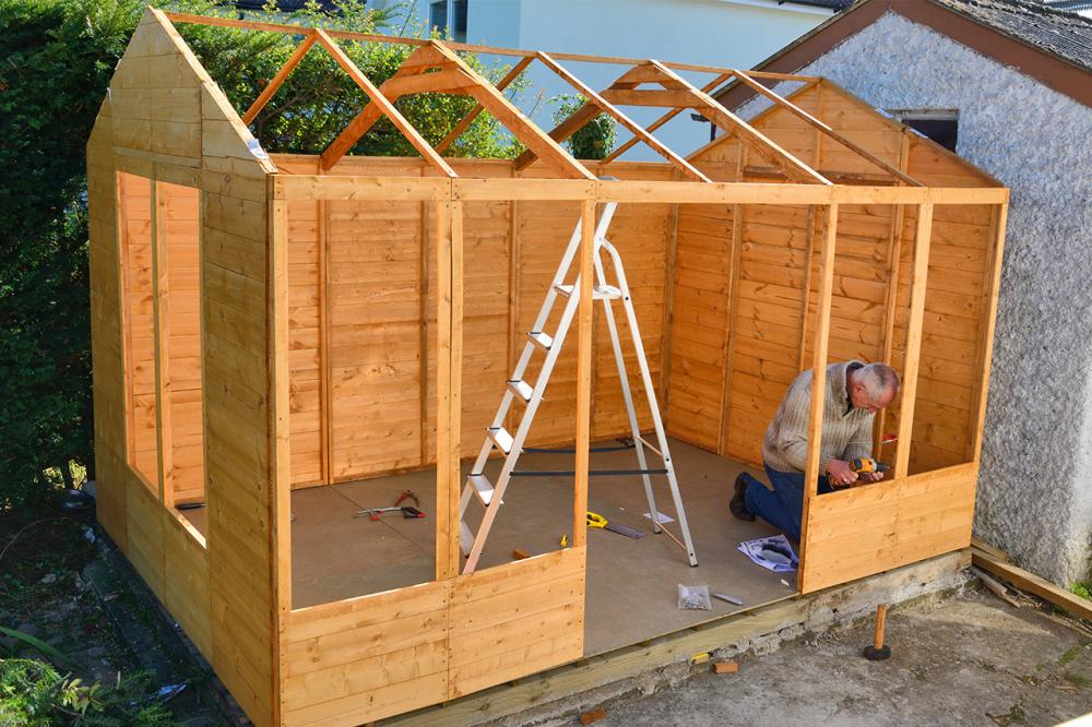 a man building with log cabin wood and shed timber 