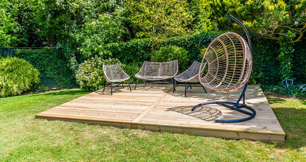 a floating deck on a lush green lawn surrounded by greenery