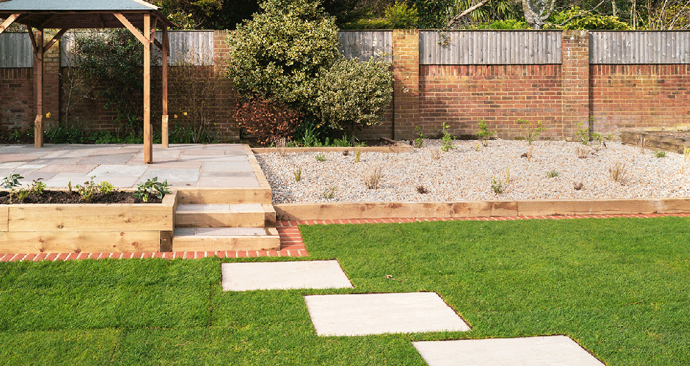 Railway sleepers being used as steps up to a covered patio area.
