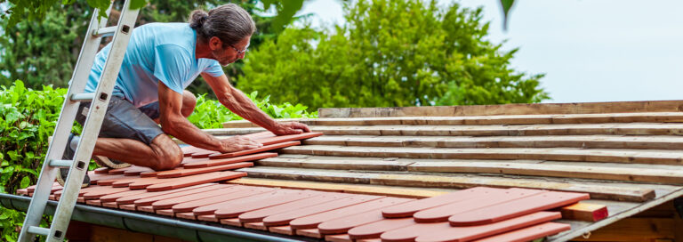 a homeowner demonstrating how to waterproof a shed
